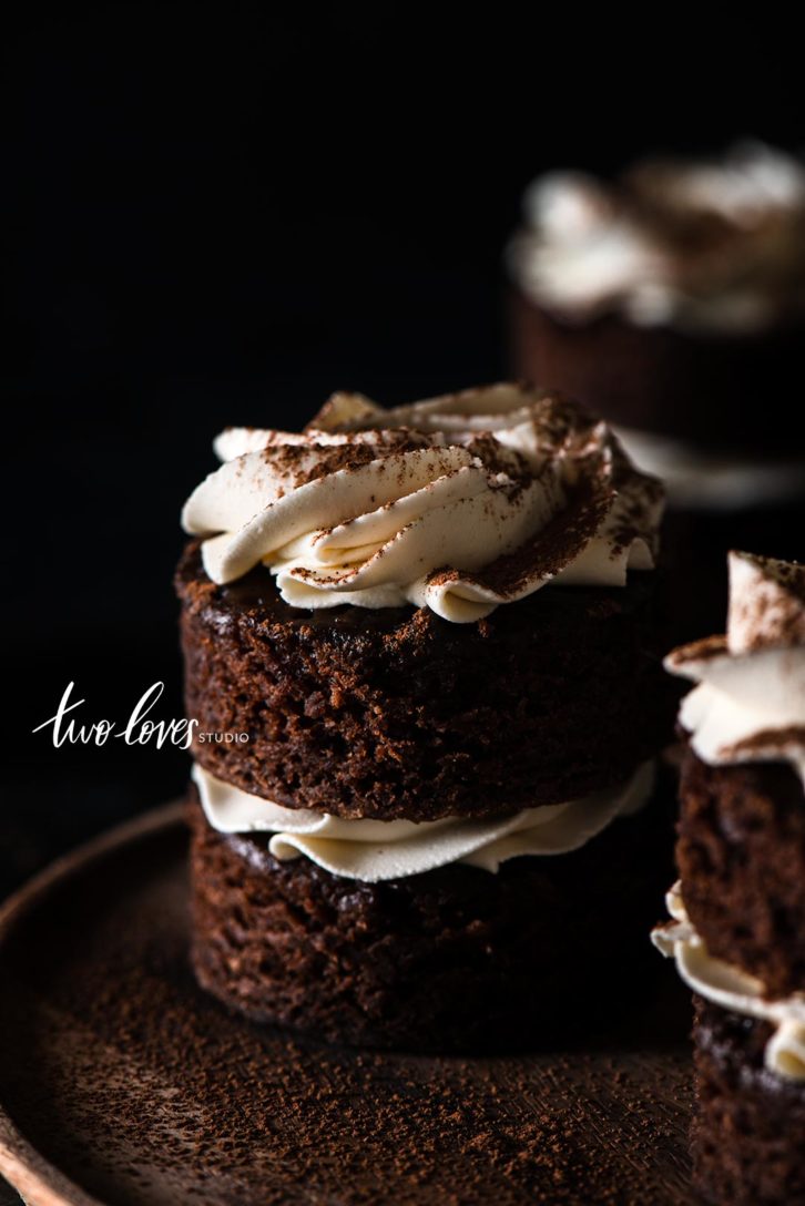 Small black cakes with white frosting