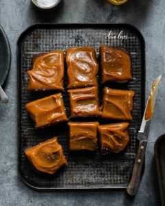 Cake cut into square pieces with caramel topping.